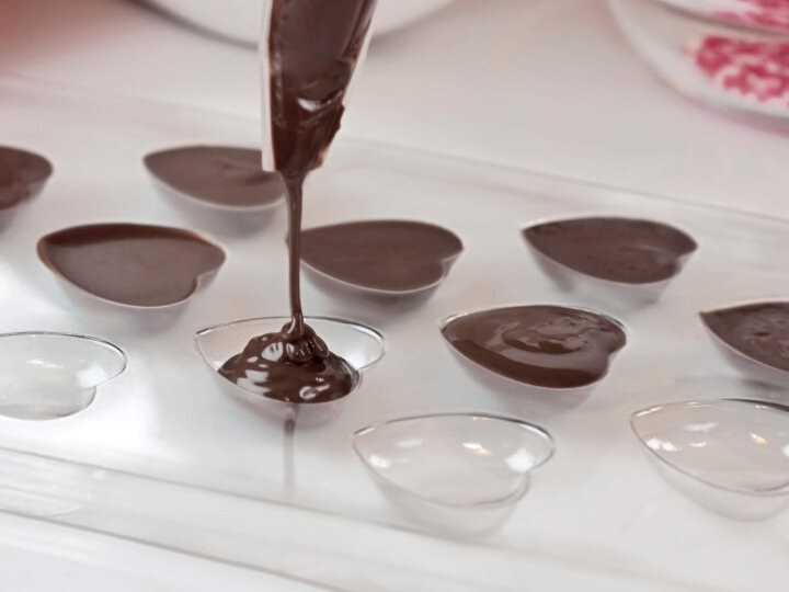 Filling a candy mold with chocolate