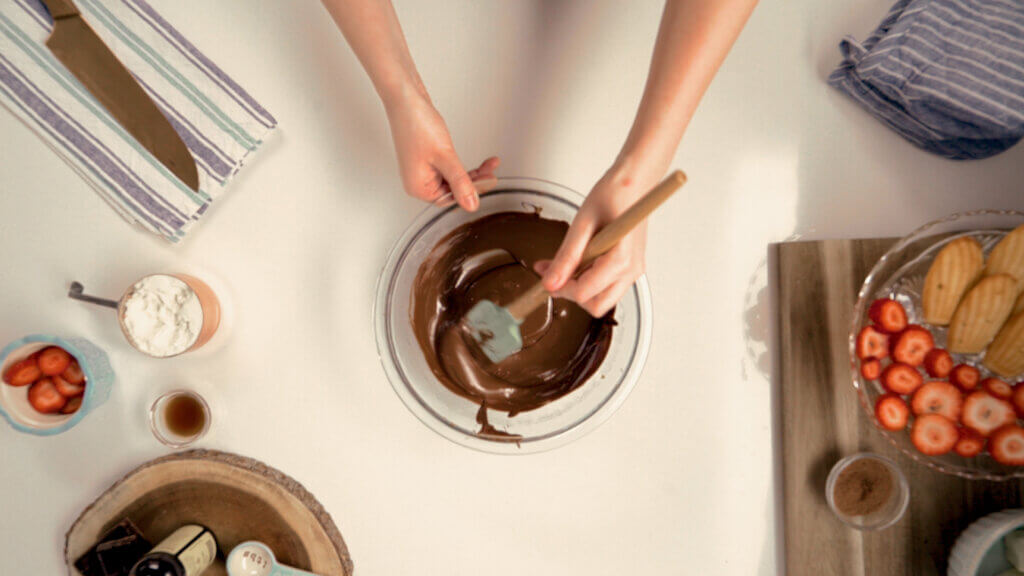 Stirring chocolate on a counter top 
