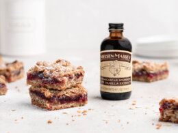 Cranberry Cardamom Oatmeal Streusel Bars with bottle of Nielsen-Massey Madagascar Bourbon Pure Vanilla Extract