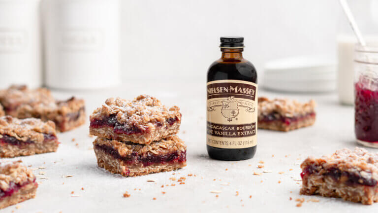 Cranberry Cardamom Oatmeal Streusel Bars with bottle of Nielsen-Massey Madagascar Bourbon Pure Vanilla Extract